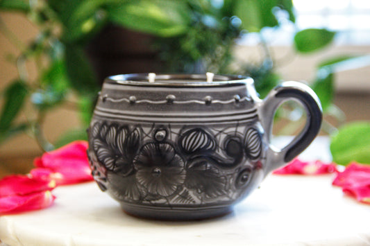 Artisanal candle in a beautiful black and grey handmade flower design talavera cup with handle. Handcrafted by Artisan in Puebla, Mexico. 100% All Natural Soy Candle. Reuse the talavera as home decor or storage.