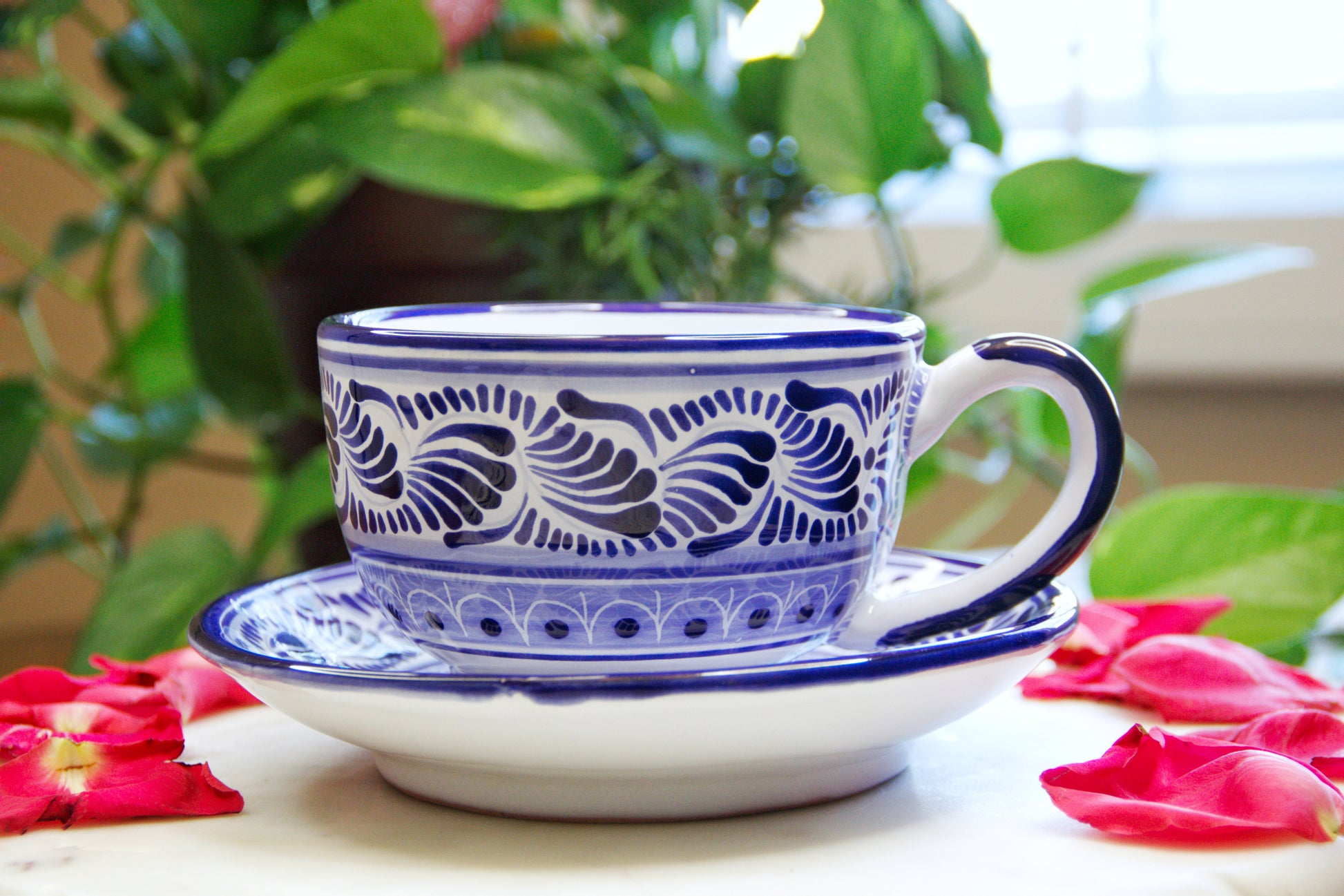 Artisanal candle in a beautiful blue and white hand designed talavera cup and plate with the cup placed on the plate. Handcrafted by Artisan in Puebla, Mexico. 100% All Natural Soy Candle. Reuse the talavera as home decor or storage.