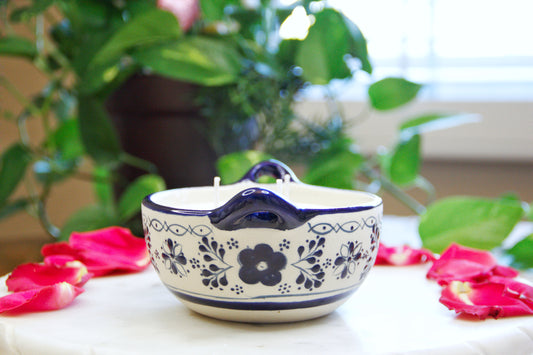 side view of an Artisanal candle in a beautiful salsa talavera bowl. Handmade blue floral design. Handcrafted by Artisan in Mexico City. 100% All Natural Soy Candle. Reuse the talavera as home decor or storage.