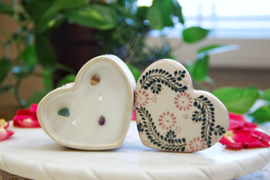 hand poured Artisanal candle in a beautiful heart shaped talavera. Handmade pink floral design. Handcrafted by Artisan in Mexico City. 100% All Natural Soy Candle. Reuse the talavera as home decor or storage.