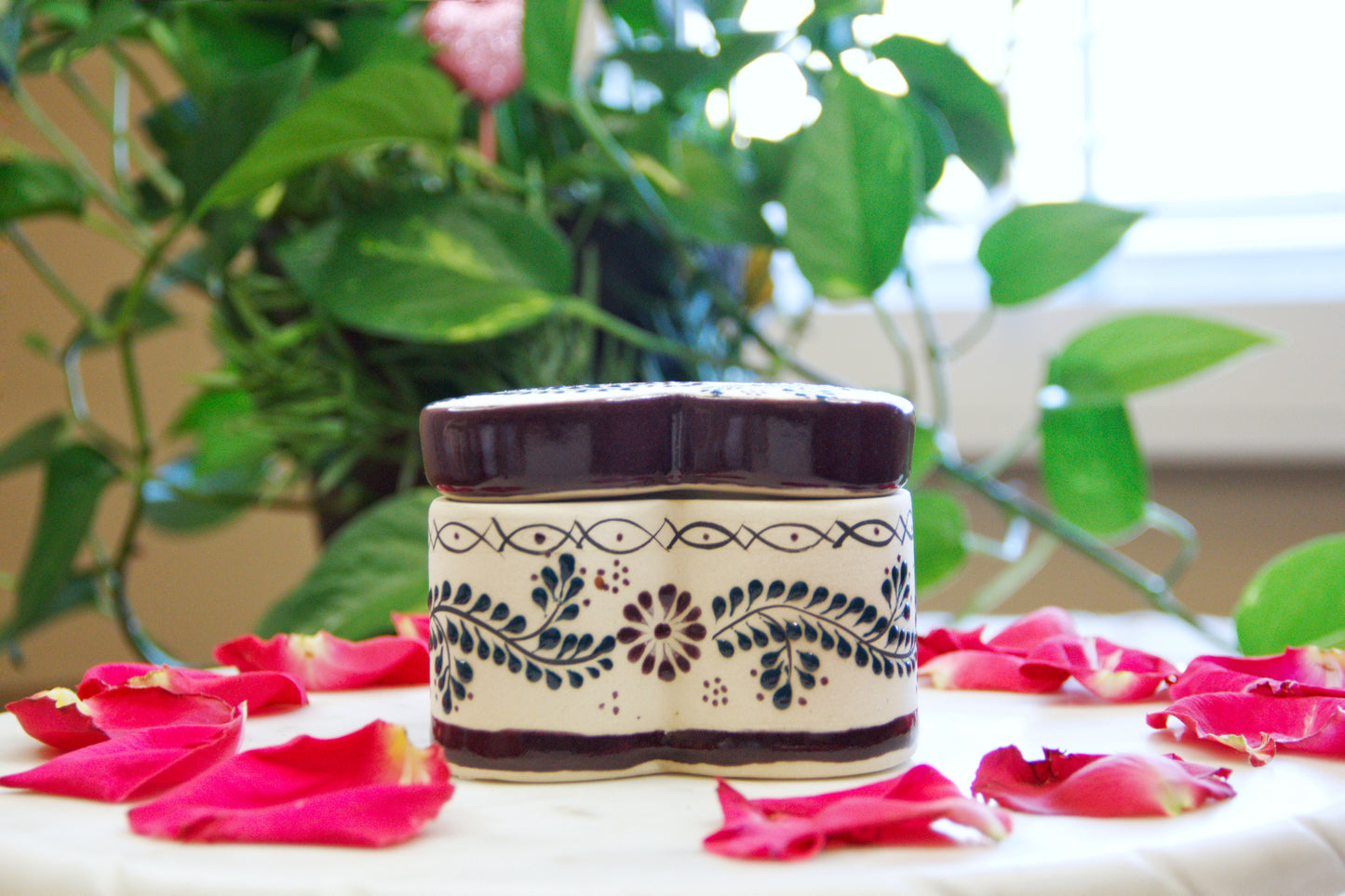 Artisanal candle in a beautiful heart shaped talavera. Handmade brown floral design with a closed lid. Handcrafted by Artisan in Mexico City. 100% All Natural Soy Candle. Reuse the talavera as home decor or storage.