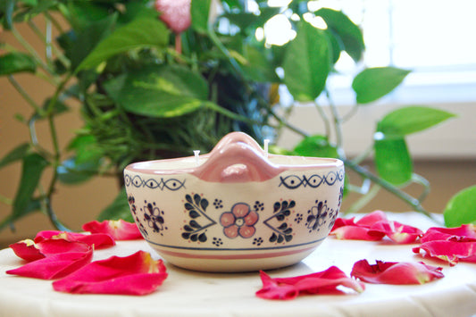 side view of Artisanal candle in a beautiful salsa talavera bowl. Handmade pink floral design. Handcrafted by Artisan in Mexico City. 100% All Natural Soy Candle. Reuse the talavera as home decor or storage.