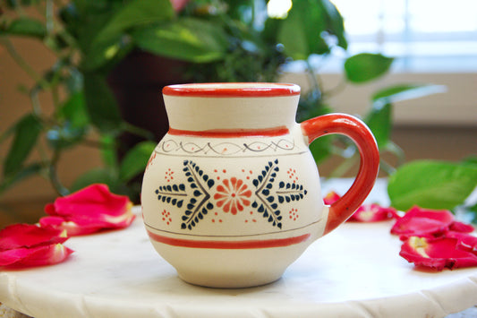 handmade artisanal candle in a red floral design mug with a handle. Custom made by Artisan in Mexico. 100% All Natural Soy Candle. Reuse the talavera as home decor or storage