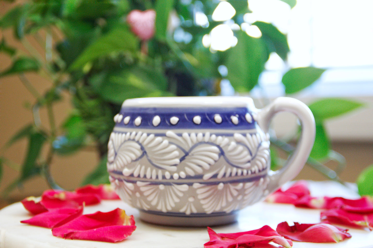 Front view of the artisanal candle. Blue Grey color with white hand painted design. Handcrafted by Artisan in Puebla, Mexico. 100% All Natural Soy Candle. Reuse the talavera as home decor or storage.