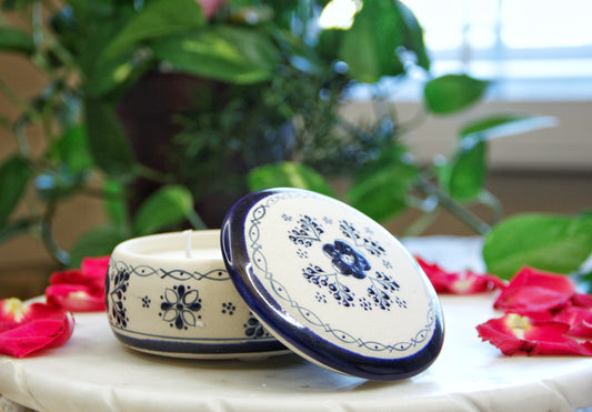 handmade artisanal candle in a blue floral design talavera with an open lid. Custom made by Artisan in Mexico. 100% All Natural Soy Candle. Reuse the talavera as home decor or storage.
