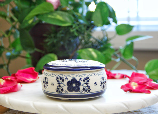 handmade artisanal candle in a blue floral design talavera with a closed lid. Custom made by Artisan in Mexico. 100% All Natural Soy Candle. Reuse the talavera as home decor or storage.