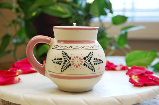 handmade artisanal candle in a pink floral design mug with a handle. Custom made by Artisan in Mexico. 100% All Natural Soy Candle. Reuse the talavera as home decor or storage