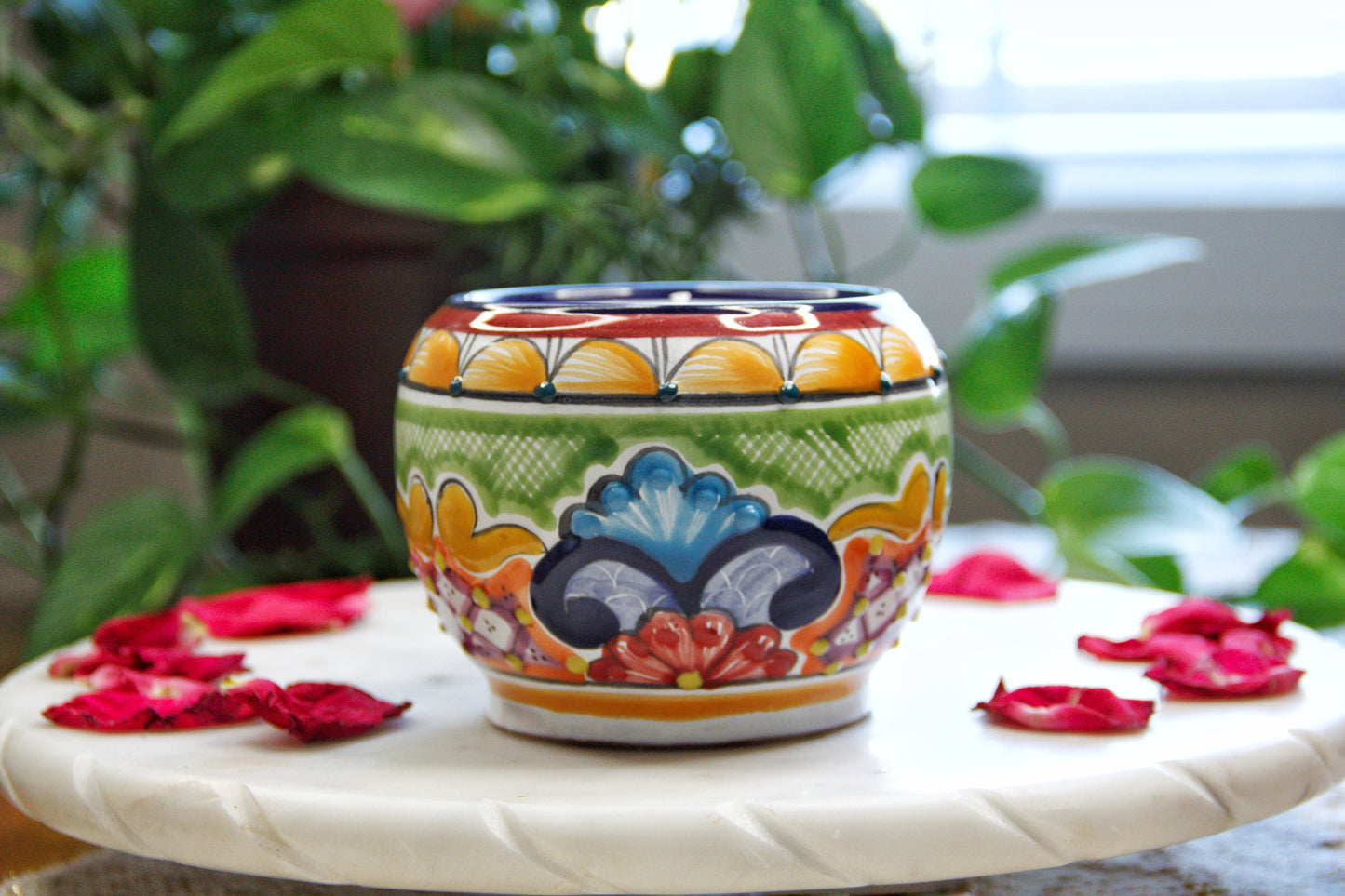 Side view of the handmade artisanal. Multicolor chocolatera design custom made by Artisan in Mexico. 100% All Natural Soy Candle.  Reuse the talavera as home decor or storage.