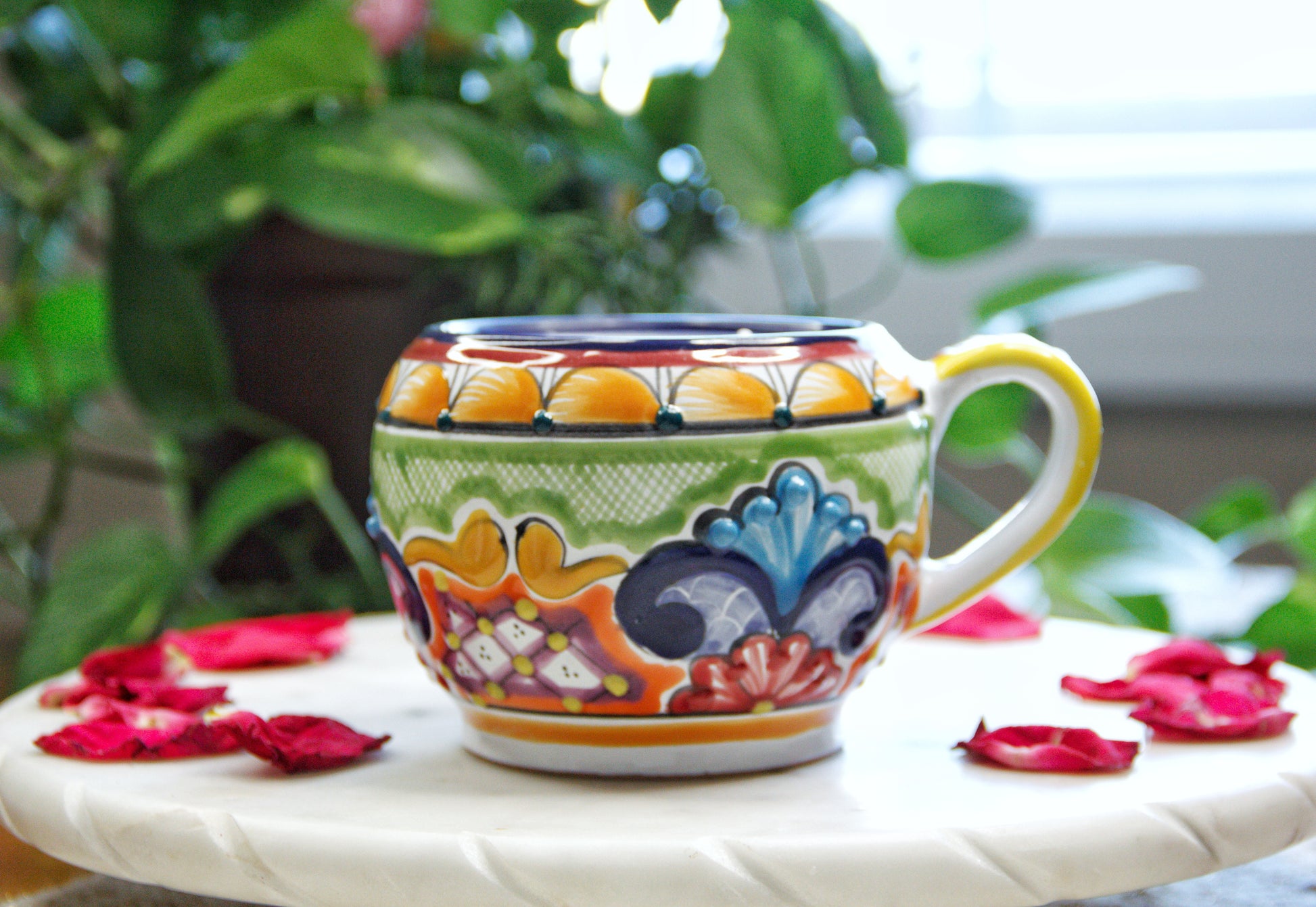 Front view of the handmade artisanal. Multicolor chocolatera design custom made by Artisan in Mexico. 100% All Natural Soy Candle.  Reuse the talavera as home decor or storage.