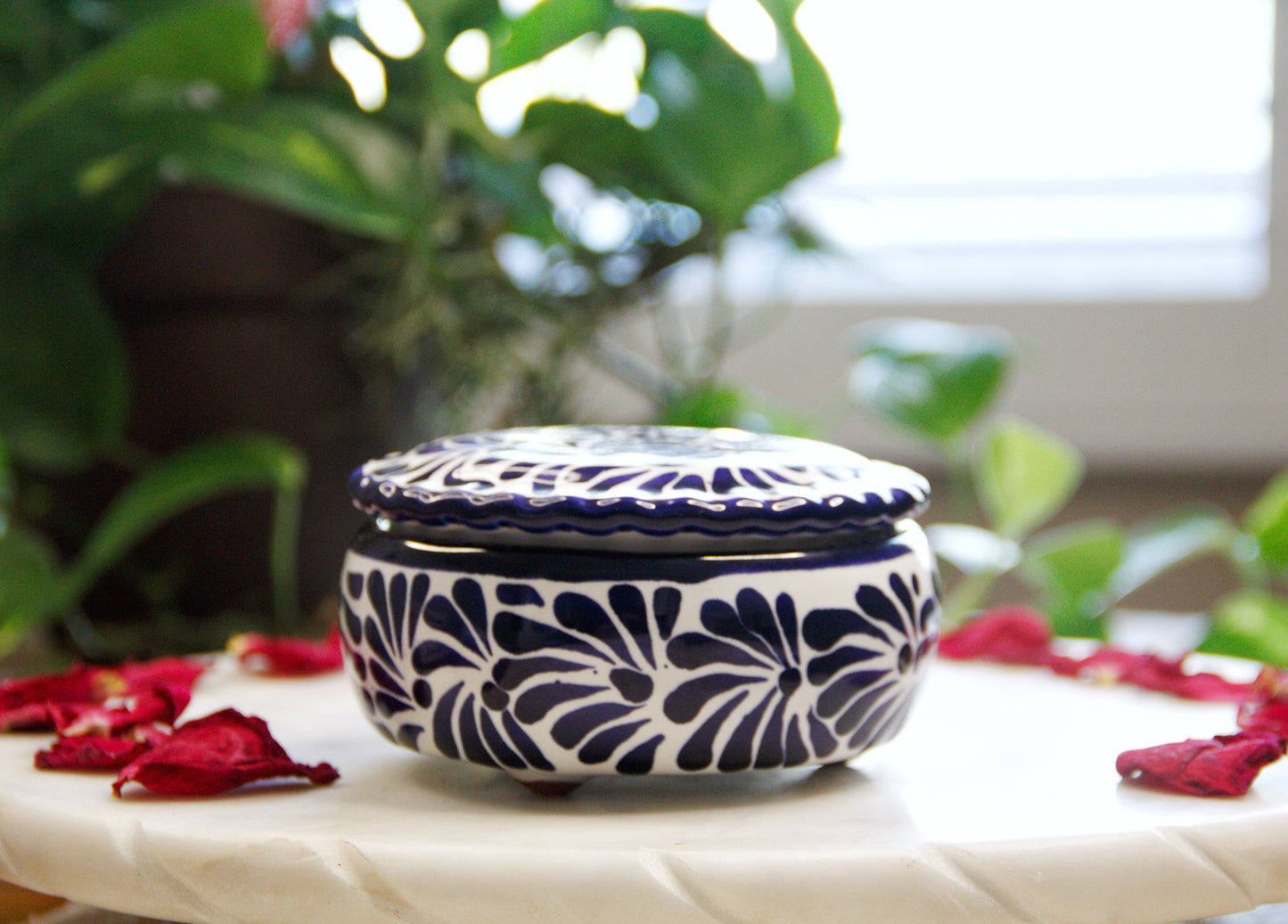 Front view of the Artisanal candle in a beautiful closed lid talavera with hand made blue strokes design. Handcrafted by Artisan in Puebla, Mexico. 100% All Natural Soy Candle. Reuse the talavera as home decor or storage.