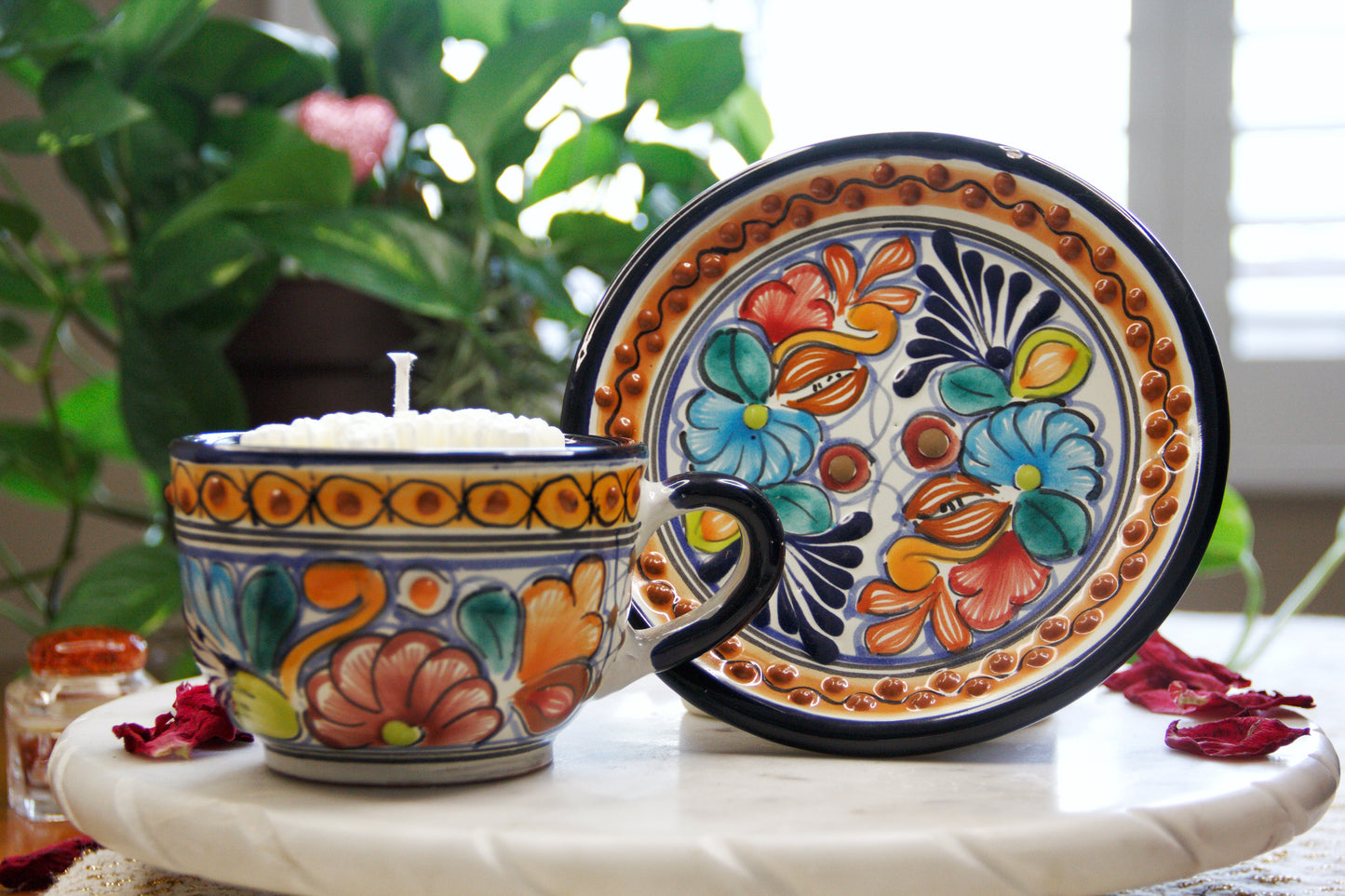 Artisanal candle in a beautiful multicolored floral talavera cup and the plate on the side. Handcrafted by Artisan in Puebla, Mexico. 100% All Natural Soy Candle. Reuse the talavera as home decor or storage.