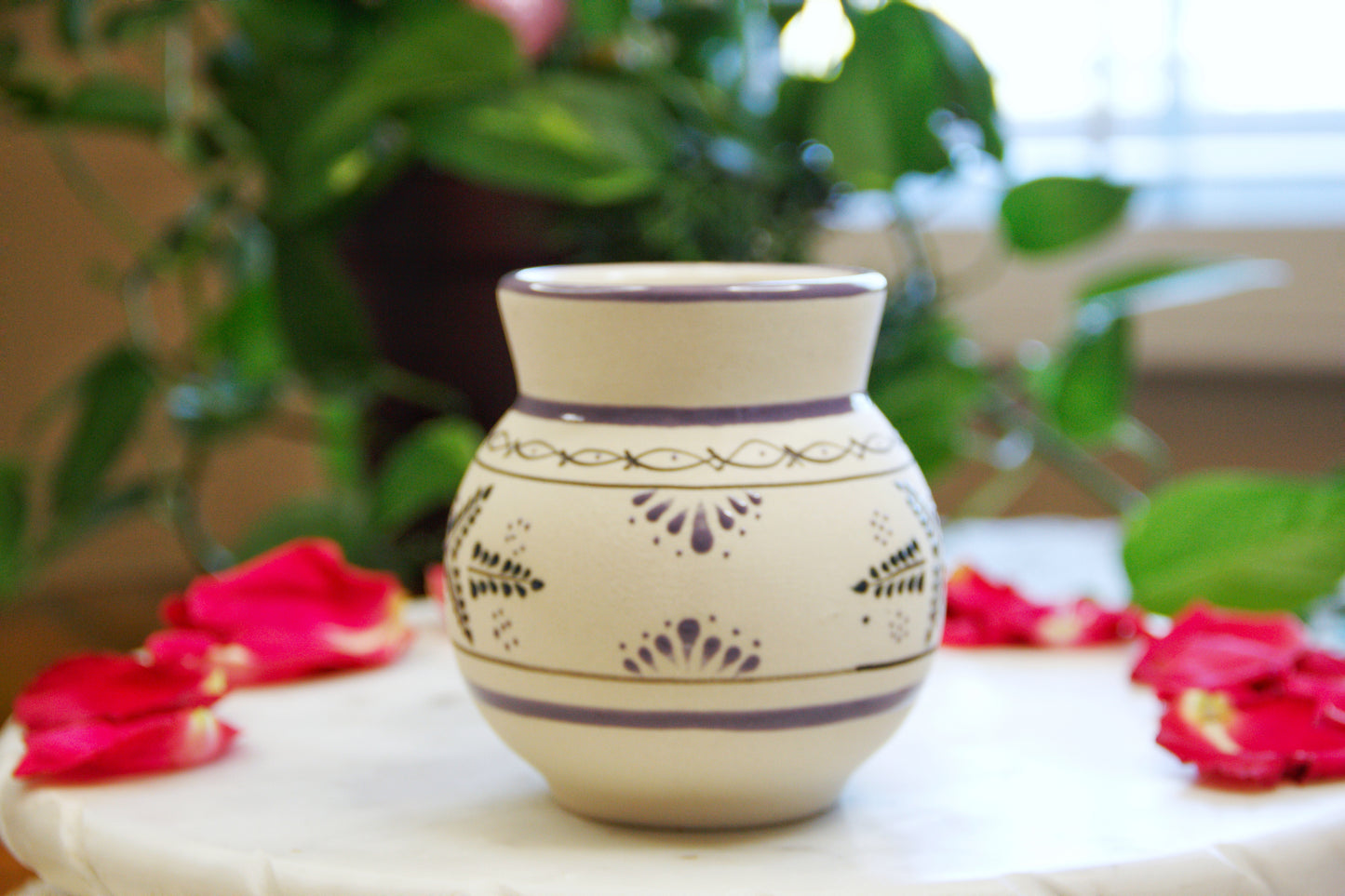 side view of a handmade artisanal candle in an indigo floral design mug. Custom made by Artisan in Mexico. 100% All Natural Soy Candle. Reuse the talavera as home decor or storage