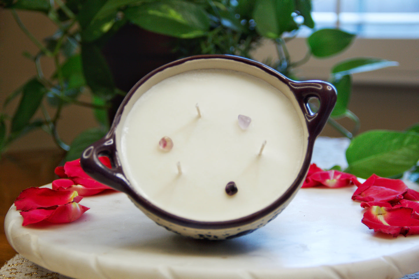 Titled top view of an Artisanal candle in a beautiful salsa talavera bowl. Handmade indigo floral design. Handcrafted by Artisan in Mexico City. 100% All Natural Soy Candle. Reuse the talavera as home decor or storage.