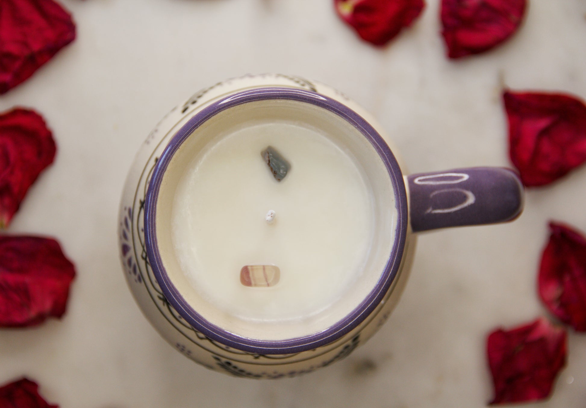 top view of a handmade artisanal candle in an indigo floral design mug with a handle. Custom made by Artisan in Mexico. 100% All Natural Soy Candle. Reuse the talavera as home decor or storage